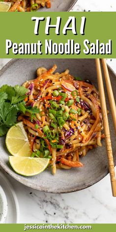 thai noodle salad in a bowl with chopsticks and lime on the side