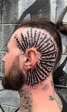 a man with tattoos on his face and neck