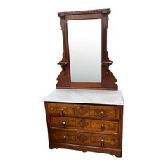 an antique dresser with mirror and marble top