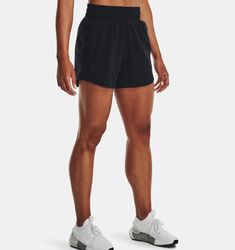 a man in black shorts and no shirt is standing with his hands on his hips