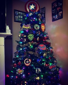 the avengers christmas tree is decorated with all kinds of stickers on it's top