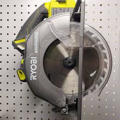 a circular saw is on the wall next to a tool holder with tools in it