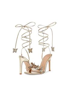 Elevate your style with these stunning Reina gold butterfly lace-up heels. Designed for the modern fashionista, these heels feature a striking butterfly motif that wraps elegantly around the ankle, adding a touch of whimsy and charm. The lace-up design provides a secure fit while showcasing an ultra-feminine silhouette. Crafted with a high stiletto heel, these sandals are perfect for special occasions, nights out, or adding a glamorous flair to any outfit. Details Elegant gold color with a gloss Heels Butterfly, Butterfly Heels, Butterfly Embellishment, Butterfly Lace, Unique Butterfly, Butterfly Motif, Floral Heels, Floral Sandals, Girls Heels