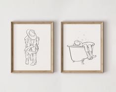 two framed drawings depicting people sitting in bathtubs