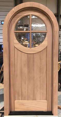 a wooden door with an arched glass window