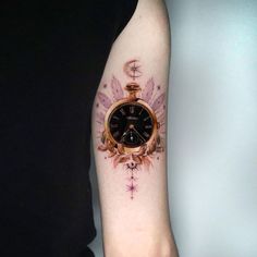 a person with a tattoo on their arm has a pocket watch tattooed on the wrist