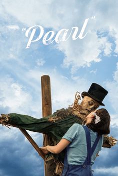 two people dressed as scarecrows hugging each other on a wooden pole with the words peace above them