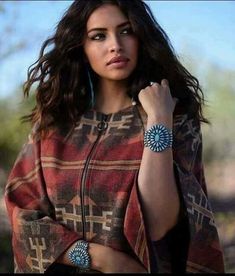 a woman in a ponchy jacket and matching bracelets