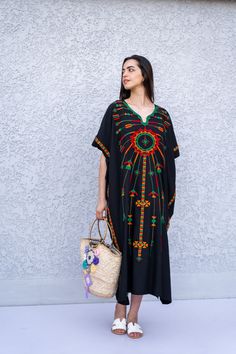 "This beautiful Kaftan with the Siwa inspired embroidery is a bohemian and flashy dress that will catch everyone's eyes. This Kaftan is ideal to wear for any casual occasion. Whether taking a trip down the shopping lane, or home-based kitty parties, or about anything else, wearing this dress will make you feel classy and comfortable. Fabric : 70% Egyptian Cotton; 30% Polyester. Size : Free sized dress. This Kaftan is a free sized dress meaning that it comes in one size only that fits any size fr Black Cotton Free Size Dress, Black Cotton Dress Free Size, Black Free Size Cotton Dress, Black Folk Style Beach Dress, Black Cotton Folk Embroidered Dress, Black Bohemian Cotton Kaftan, Black Cotton Bohemian Kaftan, Black Bohemian Embroidered Dress With Geometric Pattern, Black Cotton Embroidered Short Sleeve Dress