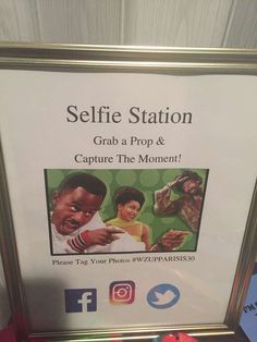 a sign that says selfie station grab a prop & capture the moment