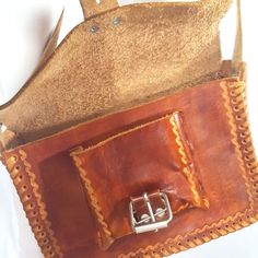 "Vintage Tan Leather Tooled Crossbody Bag Purse Real leather Hand made Tooled 10\" x 7\" 3\" bottom Adjustable fits 20\" to 25\" Good vintage condition has some minor marks on the bottom in the back. * Please review shop policies before completing transaction. All sales final. No returns/exchanges." Leather Crossbody Satchel With Cell Phone Pocket, Leather Tote Satchel With Cell Phone Pocket, Leather Saddle Bag Satchel With Cell Phone Pocket, Leather Briefcase With Cell Phone Pocket, Leather Briefcase With Cell Phone Pocket As Shoulder Bag, Vintage Satchel Shoulder Bag With Cell Phone Pocket, Vintage Rectangular Satchel With Cell Phone Pocket, Metallic Blouses, Fringe Purse