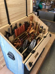 a wooden box filled with lots of different types of tools and gadgets in it