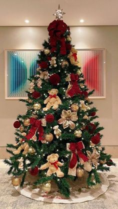 a christmas tree decorated with teddy bears and bows