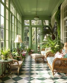 a green room with wicker furniture and potted plants