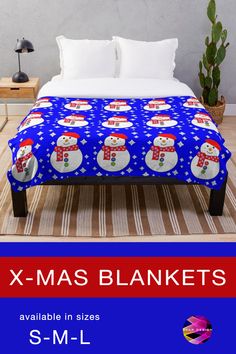 a bed covered in a blue blanket with snowmen on it and the text x - mas blankets available in sizes s m l