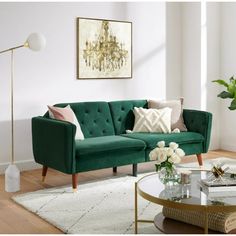 a living room with a green couch and coffee table