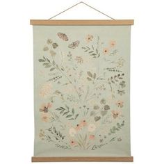 an embroidered wall hanging with flowers and butterflies on the front, in light green color