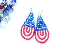 red, white and blue beaded earrings next to beads