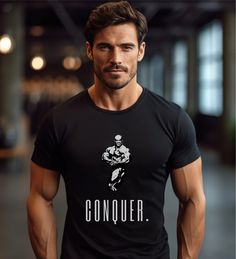 --- Ronnie Coleman Conquer Bodybuilding T-Shirt --- This bodybuilding t-shirt, from our new gym collection, is designed to elevate your workout wardrobe to the next level. Crafted from 100% cotton, this shirt offers unmatched comfort and breathability. With both a retro and modern design, it is as stylish as it is functional.   The t-shirt runs true to size - if you pretend a more oversized look, go for one or two upper sizes. Please check the size chart available in the photos. ▶ 100% Cotton (a Branded Crew Neck Workout T-shirt, Black Branded T-shirt For Gym, Black Graphic Tee For Gym, Black Graphic Tee For Gym Activewear, Black Branded Gym Tops, Black Branded Tops For Gym, Black Branded Tops For The Gym, Black Sporty Muscle Tee With Letter Print, Black Short Sleeve Muscle Tee For Gym