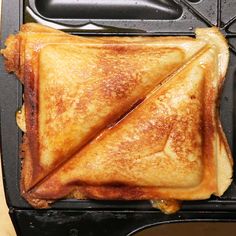 a toasted sandwich sitting on top of a black pan