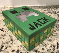 a green box with the word ajax written on it sitting on a counter next to a white wall