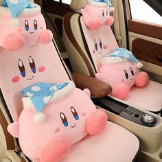 two pink stuffed animals sitting in the back of a car