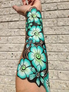 a person's arm with blue flowers on it