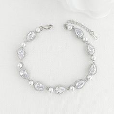 an elegant bracelet with white pearls and crystal stones