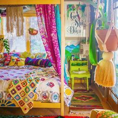 a bedroom with colorful bedding and curtains