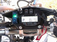 a close up of a motorcycle handlebars with a speedometer and other electronic devices