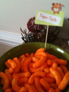 carrots in a green bowl with a sign on top