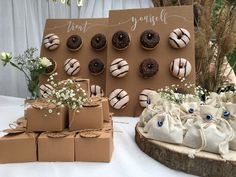 an assortment of pastries on display in front of a sign and bagged boxes