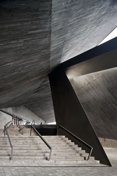 stairs leading up to the top floor of a building with concrete walls and ceilinging