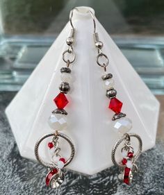 These earrings are made with bright clear red beads and accented with silver rondelles with bright red rhinestones in them.  There are also sparkling solid white faceted beads and silver beads, bead caps, and various silver loops.   These earrings measure at about 3 inches long.  They are made on silver French wires, but can be changed to posts at no extra cost to you if you would like; just message me on the message board. There is no shipping in the contiguous 48 states.  Thank you for visitin Red Beads, French Wire, Red Rhinestone, Beaded Dangle Earrings, Message Board, Red Bead, Etsy Earrings Dangle, Bead Caps, Faceted Bead