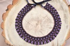 Bohemian Black Beaded Necklaces With Bead Caps, Purple Beaded Necklace With Black Beads For Gift, Handmade Purple Choker With Round Beads, Traditional Handmade Purple Beaded Necklaces, Purple Beaded Choker For Festivals, Traditional Black Beaded Choker, Purple Beaded Necklace With Round Black Beads, Handmade Purple Beaded Choker Necklace, Black Round Beaded Costume Jewelry Necklace