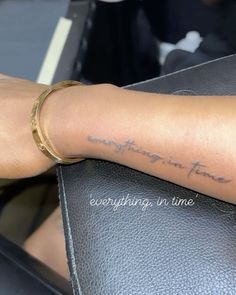 a woman with a tattoo on her arm that reads, something time everything in time