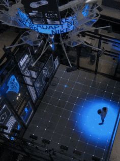 an overhead view of a person standing in the middle of a room with blue lights