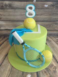 a tennis themed birthday cake with a racket and ball on it's side