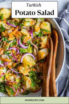 a white bowl filled with potato salad on top of a table