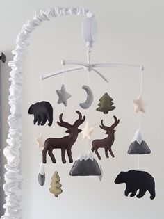 a crib mobile with animals and stars hanging from it