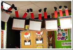 bulletin boards are hanging from the ceiling and decorated with red, white and black paper