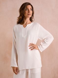 Our kaftan long sleeve tops are made from the finest imported Egyptian linen and cotton. Once the yarn arrives in Casablanca, it is transported to small villages around the town of Essaouira in southern Morocco. There, our in-house collaborative team of weavers, designers, and seamstresses produce our beautiful garments. Lightweight white kaftan long sleeve top with v-neckline, made from a linen and cotton blend. During the spring/summer months, pair this top with matching linen trousers or deni White Kaftan, Moroccan Kaftan, Beach Cover Ups, Linen Clothing, Bohemian Beach, Cover Ups, West London, Linen Trousers, Linen Clothes