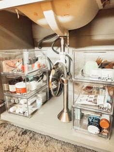 an organized bathroom sink with clear drawers