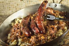 a pan filled with meat and potatoes on top of a counter