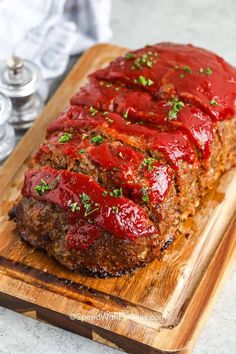 meatloaf with ketchup on a cutting board