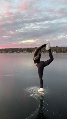 a woman standing on one leg in the water