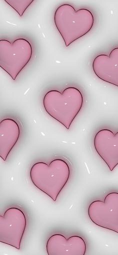 many pink hearts are arranged on a white background