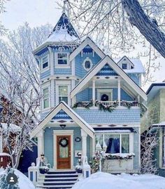 a blue and white house with snow on the ground