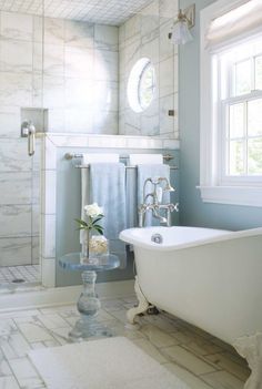 a white bath tub sitting next to a window