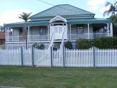 a white picket fence in front of a house